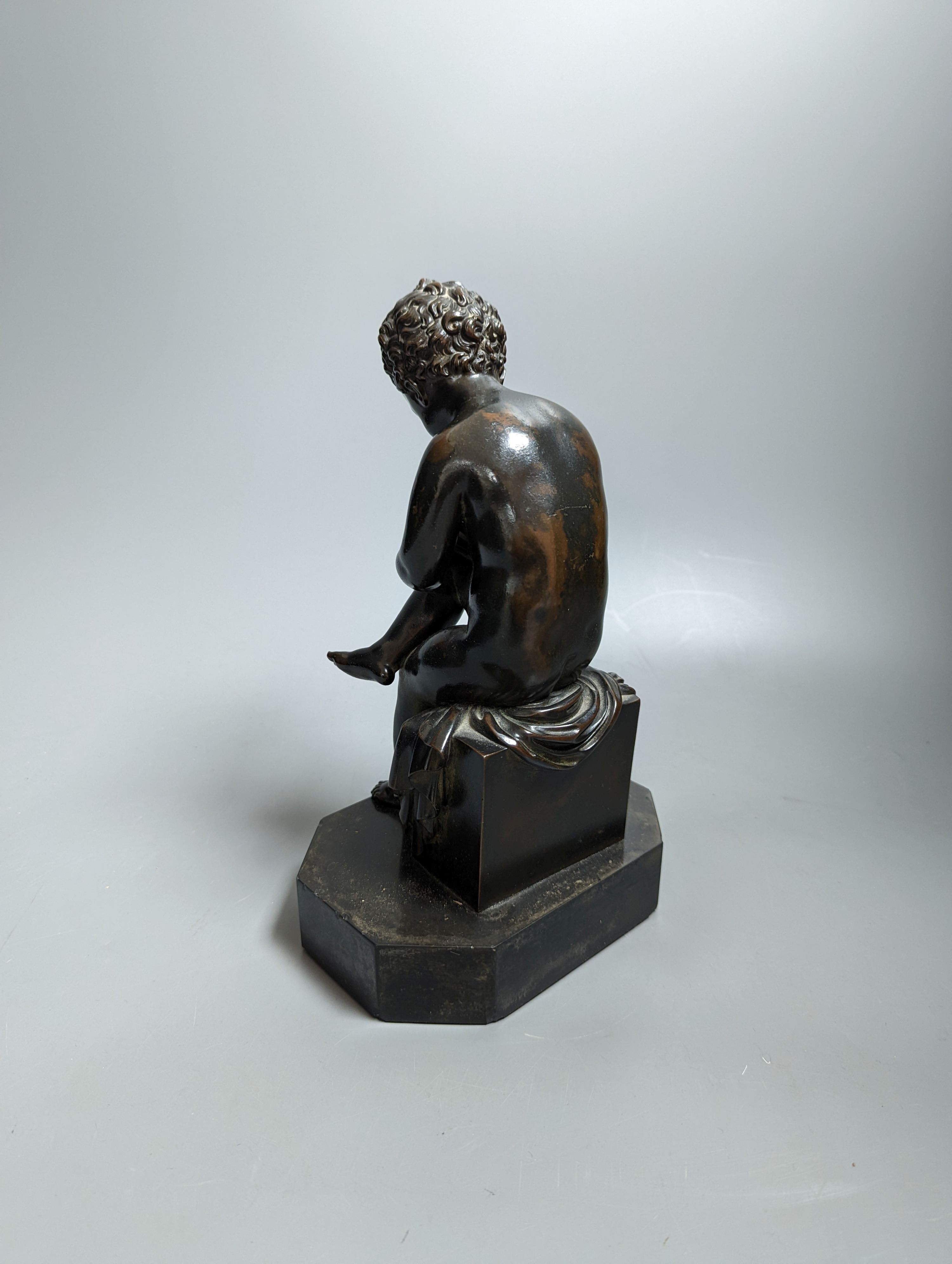 A pair of late 19th century bronze figures of seated putti plotting and writing notes, 26cm